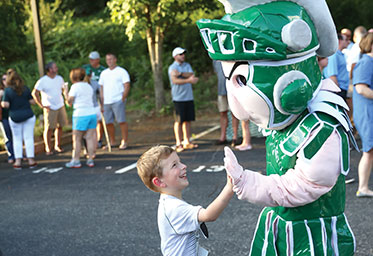 A boy giving the Webb School mascot a high five. Links to Tangible Personal Property