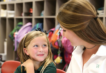 Young girl smiling and talking to an older woman. Links to Donor-Advised Funds