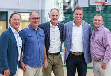 A group of men in a gymnasium, smiling. Link to Life Stage Gift Planner Ages 45-65 Situations.